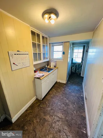 a view of kitchen with window and refrigerator