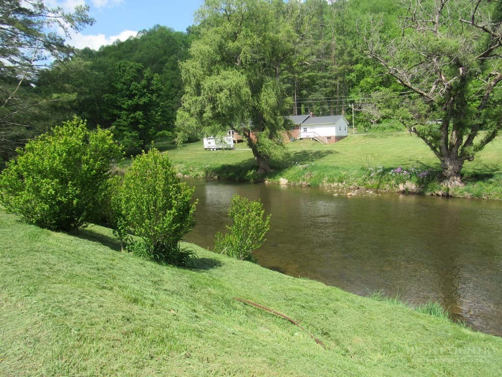 805 Ed Little Road Warrensville, NC 28693 - Photo 6 of 49 a view of a lake with a yard