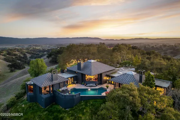 an aerial view of a house with mountain view
