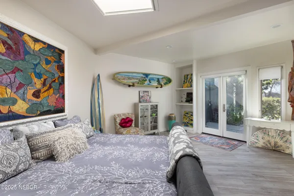 a bedroom with a large bed and a large window