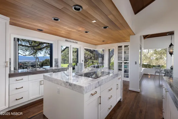 a kitchen with sink stove and refrigerator