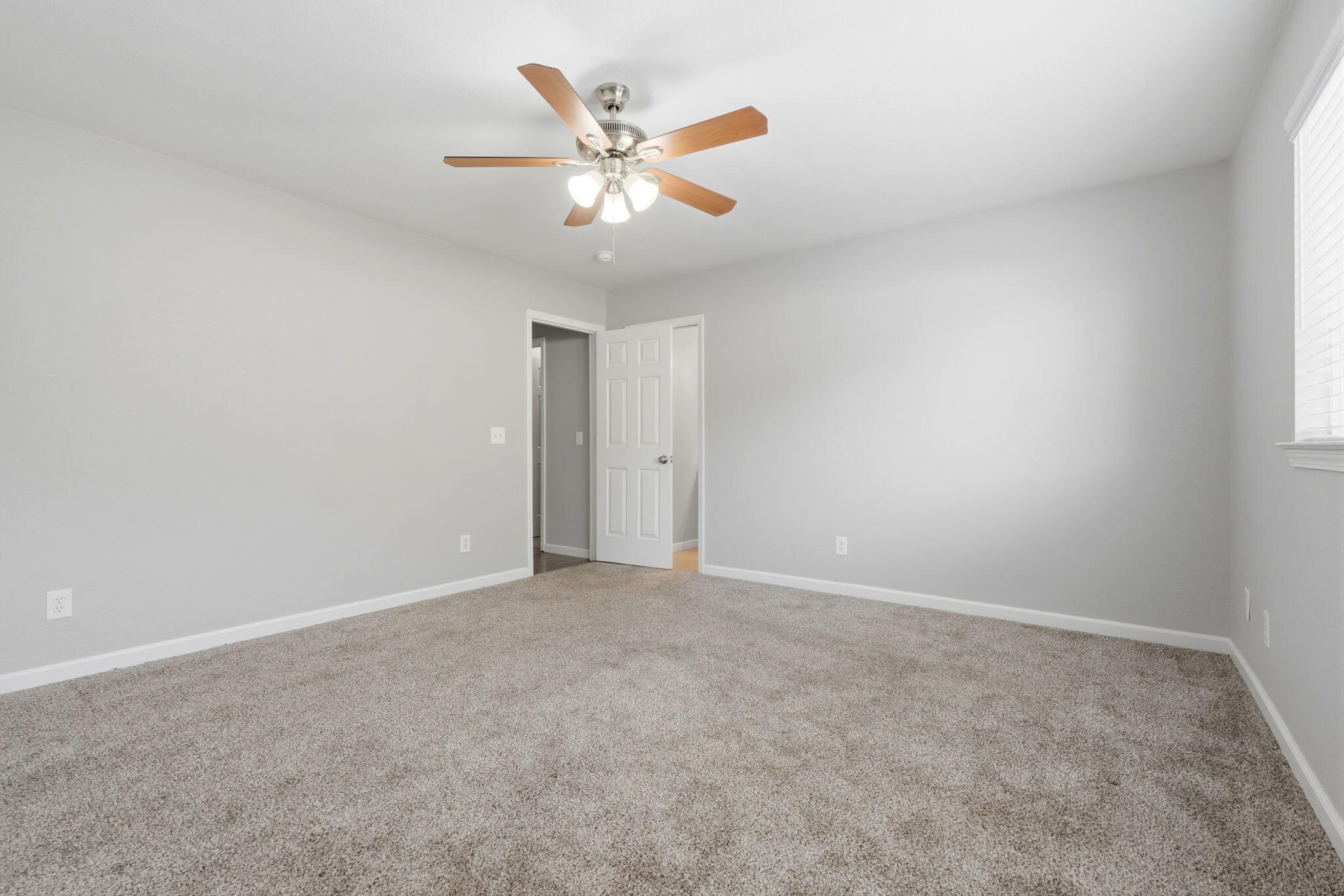 481 Katelyn Court Exeter, CA 93221 - Photo 17 of 33 an empty room with a chandelier fan and windows