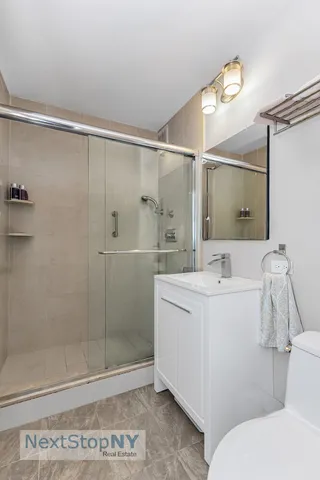 a bathroom with a sink mirror and toilet