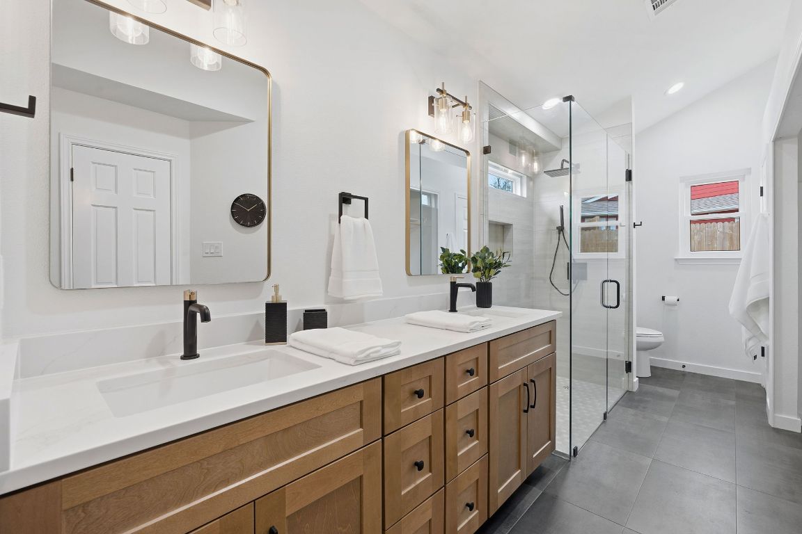 2701 Calabash Cove Austin, TX 78745 - Photo 21 of 40 a bathroom with a double vanity sink mirror double and shower