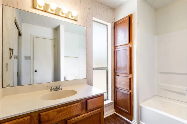 a bath room with a sink and a mirror