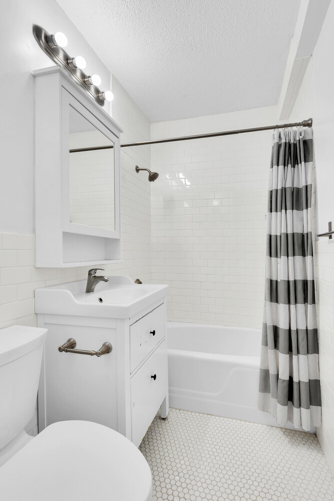 300 East 40th Street, Unit 6L Manhattan, NY 10016 - Photo 5 of 5 a bathroom with a sink a toilet and shower