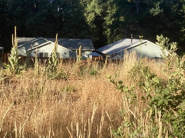 a backyard of a house with table and chairs