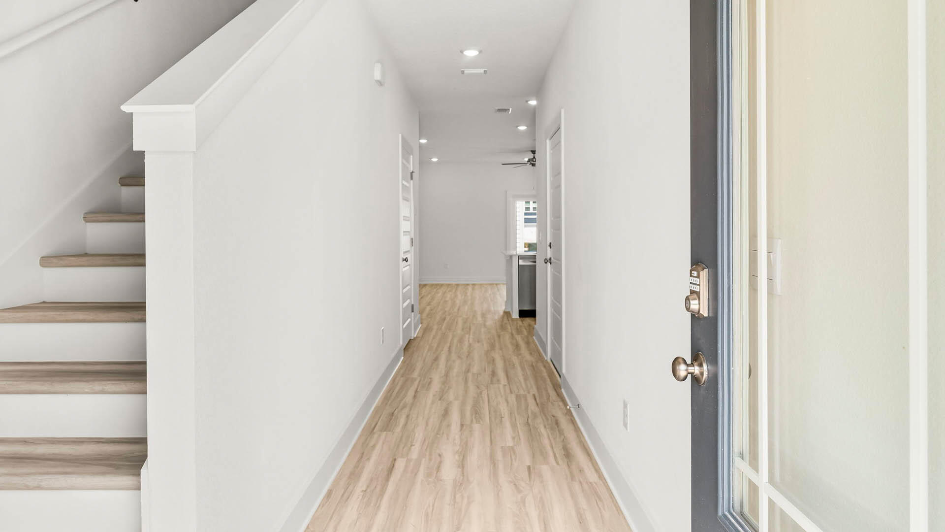 40 Hawk Street Santa Rosa Beach, FL 32459 - Photo 2 of 30 a view of a hallway with wooden floor and staircase