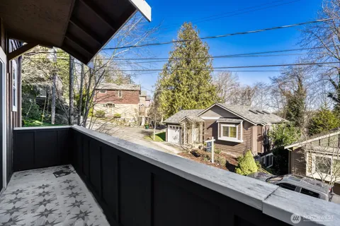 a view of house with a big yard potted plants