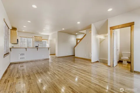 a view of a kitchen with wooden floor and a kitchen