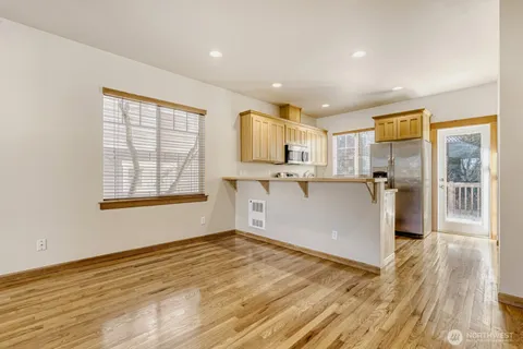 a big room with wooden floor and windows