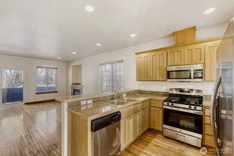 a kitchen with stainless steel appliances granite countertop a stove and a sink