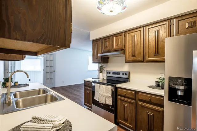 a kitchen with stainless steel appliances granite countertop a sink stove and refrigerator
