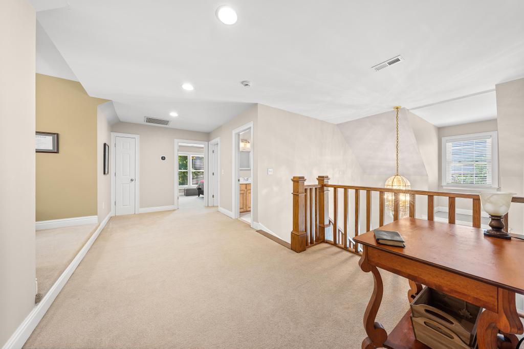 217 Maret Road Townville, SC 29689 - Photo 22 of 35 A spacious landing with a wooden railing offers a bright and inviting transitional space.