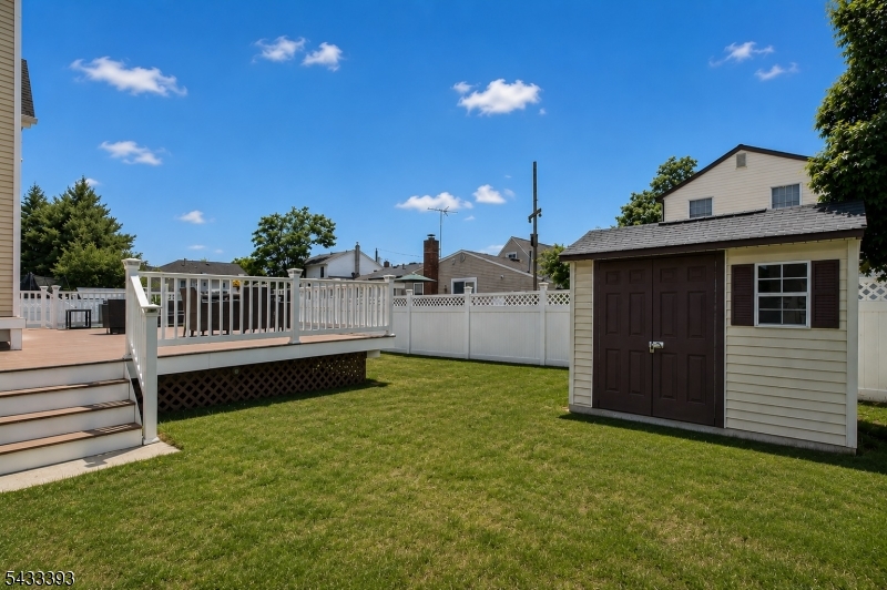 33 Stanton Street Clark, NJ 07066 - Photo 35 of 37 a view of a backyard with a garden and deck