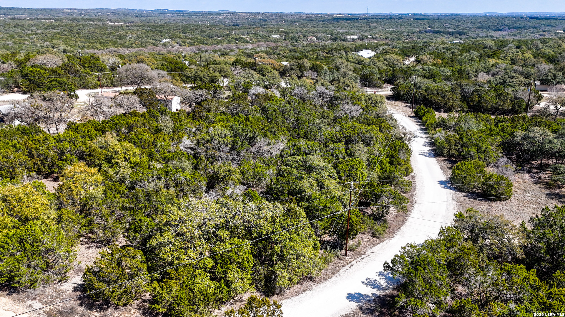 2825 Rimrock Drive Spring Branch, TX 78070 - Photo 2 of 32 an aerial view of residential houses with outdoor space and trees