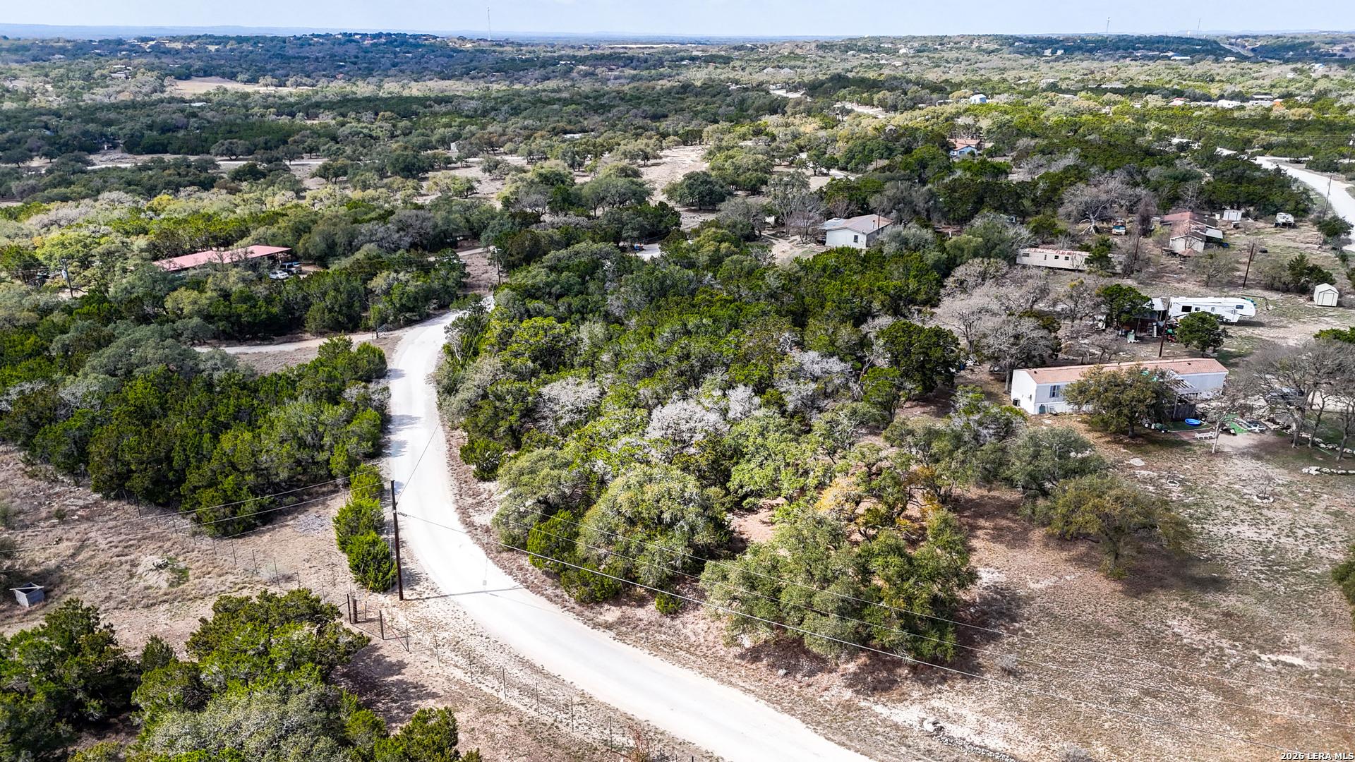 2825 Rimrock Drive Spring Branch, TX 78070 - Photo 28 of 32 an aerial view of residential houses with outdoor space and trees