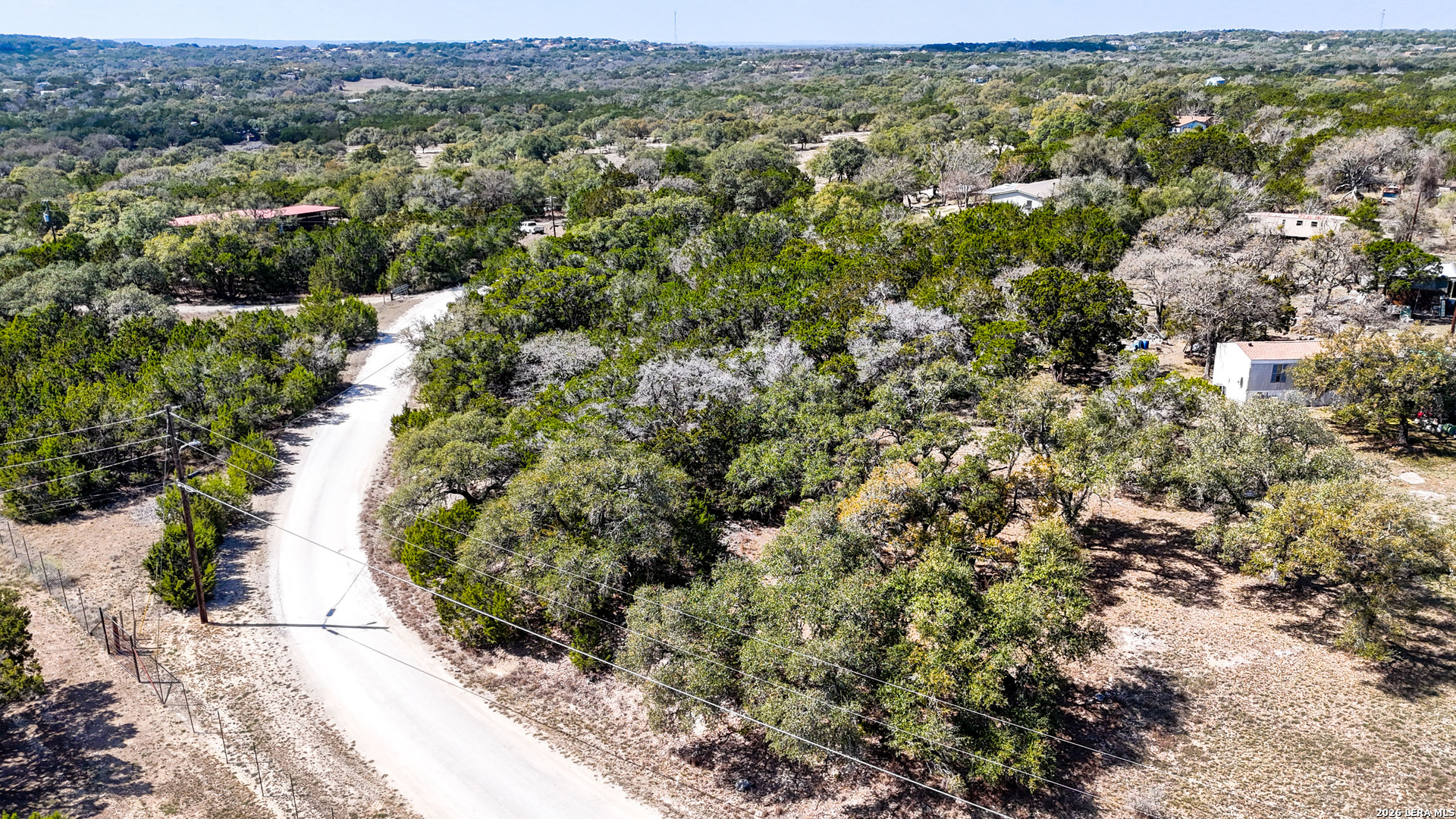 2825 Rimrock Drive Spring Branch, TX 78070 - Photo 6 of 32 an aerial view of residential houses with outdoor space and trees