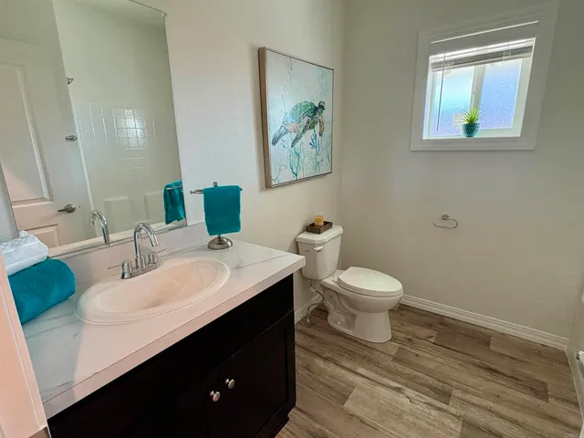 a bathroom with a toilet a sink and mirror