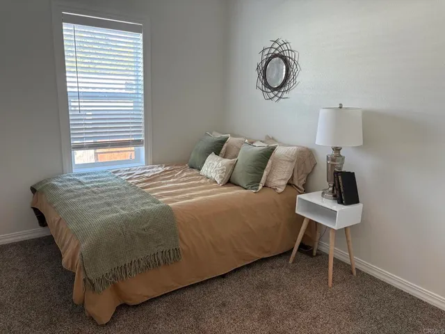 a bedroom with a bed and window