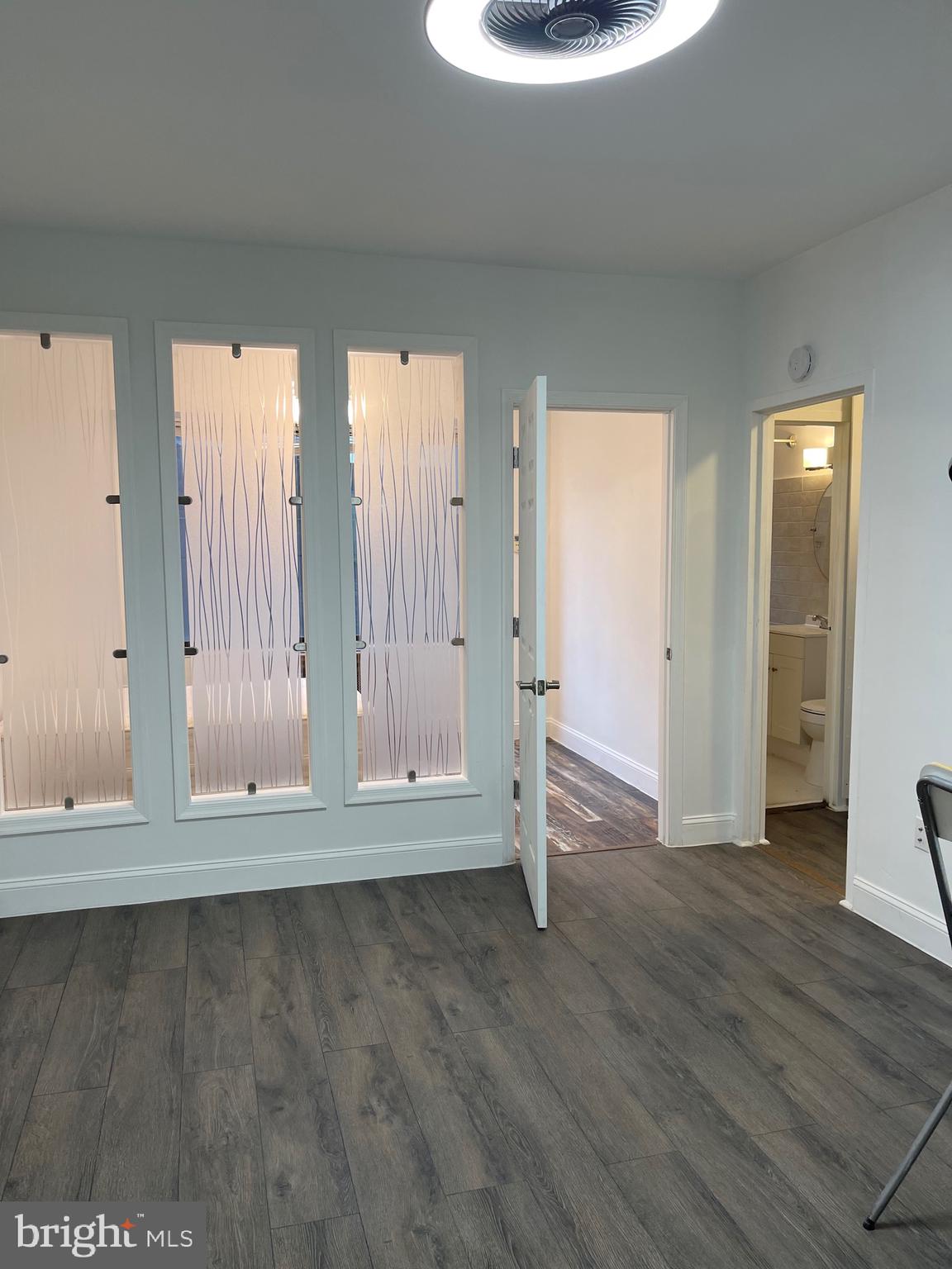 1 Scott Circle Northwest, Unit 118 Washington, DC 20036 - Photo 21 of 35 an empty room with wooden floor and windows