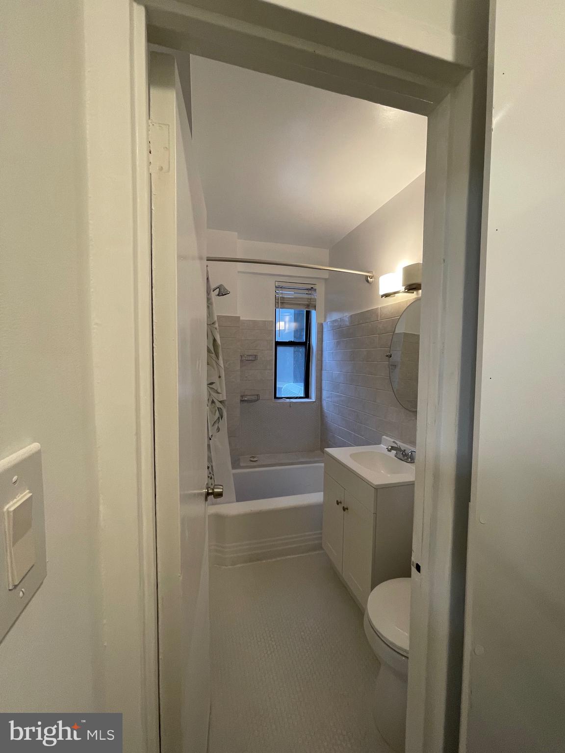 1 Scott Circle Northwest, Unit 118 Washington, DC 20036 - Photo 26 of 35 a bathroom with a granite countertop sink a toilet and shower