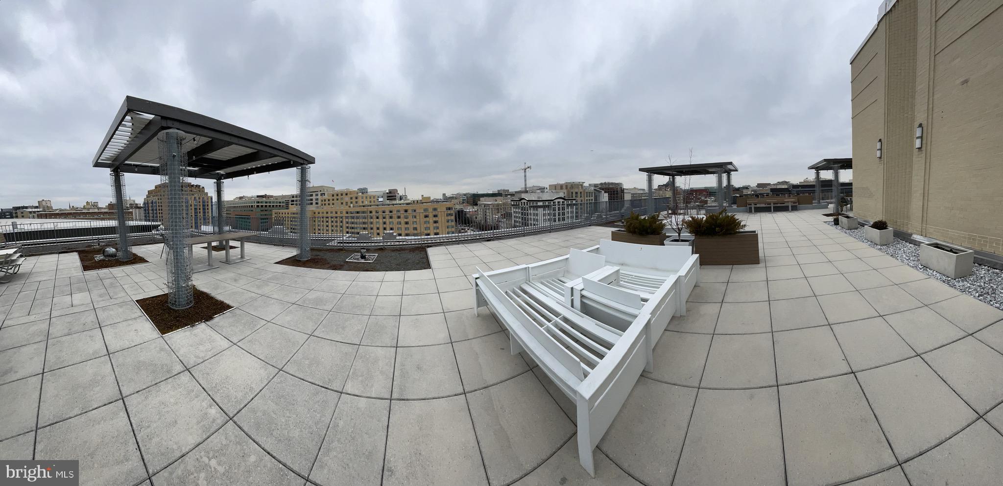 1 Scott Circle Northwest, Unit 118 Washington, DC 20036 - Photo 32 of 35 a view of roof deck with dining table and chairs with wooden floor