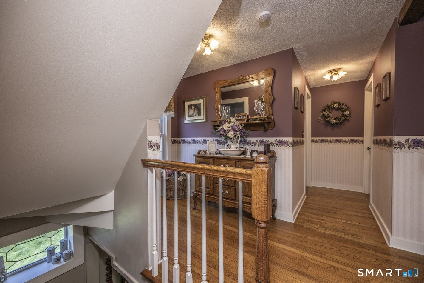175 Howd Road Durham, CT 06422 - Photo 19 of 25 The second-floor landing feels warm and welcoming with hardwood floors, charming trim details, and space for a reading nook or accent furniture.