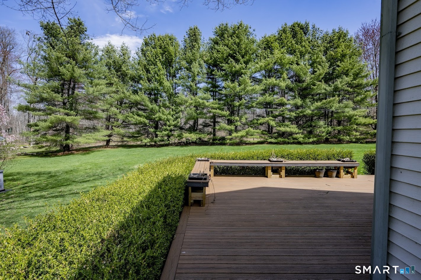 175 Howd Road Durham, CT 06422 - Photo 21 of 25 The expansive deck overlooks a private backyard lined with mature evergreens, creating the perfect spot for summer entertaining or quiet mornings with coffee.