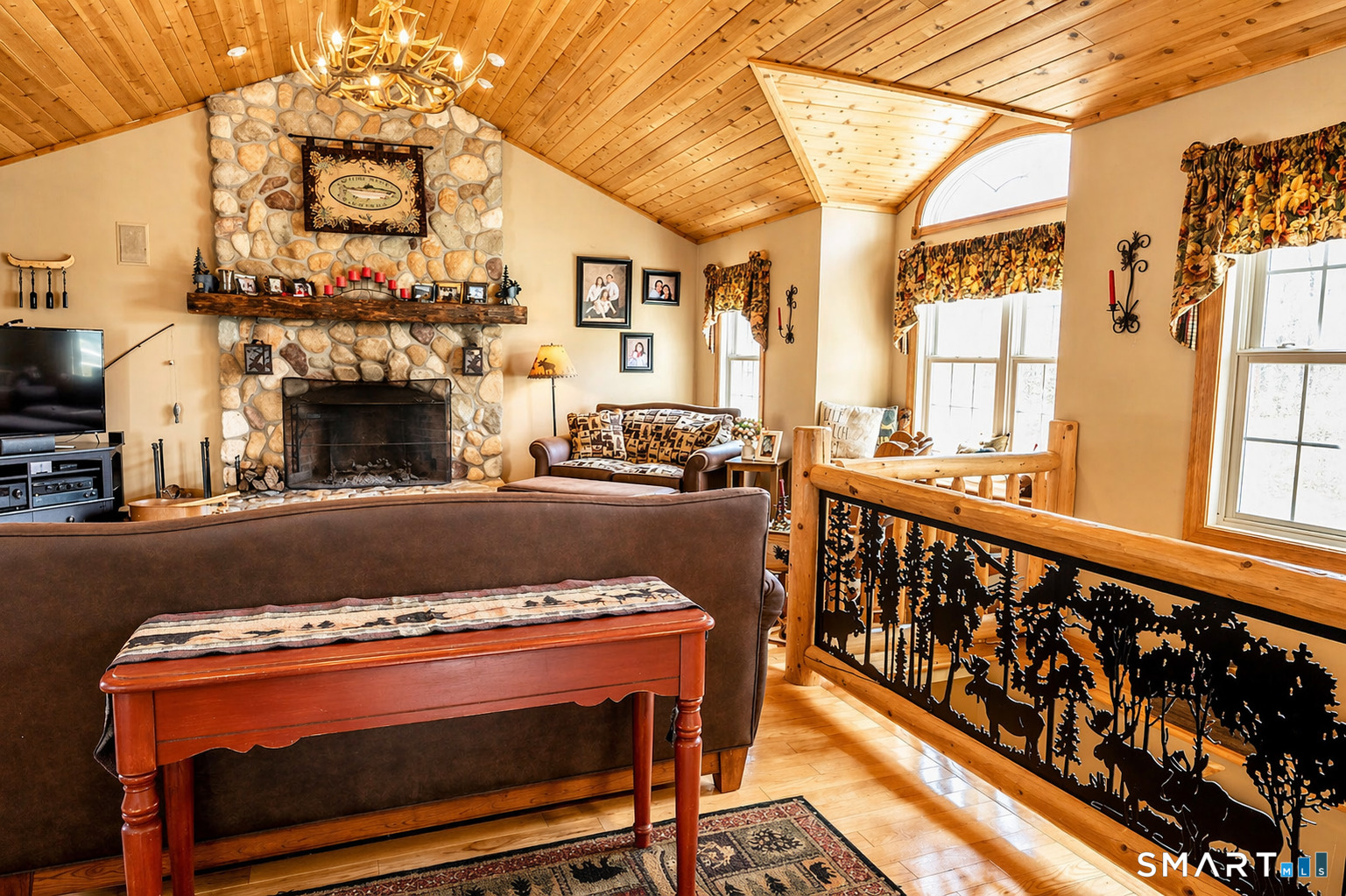 175 Howd Road Durham, CT 06422 - Photo 5 of 25 Dramatic great room featuring pine ceilings, a stunning stone fireplace and custom banister details that bring warmth and character to the space.
