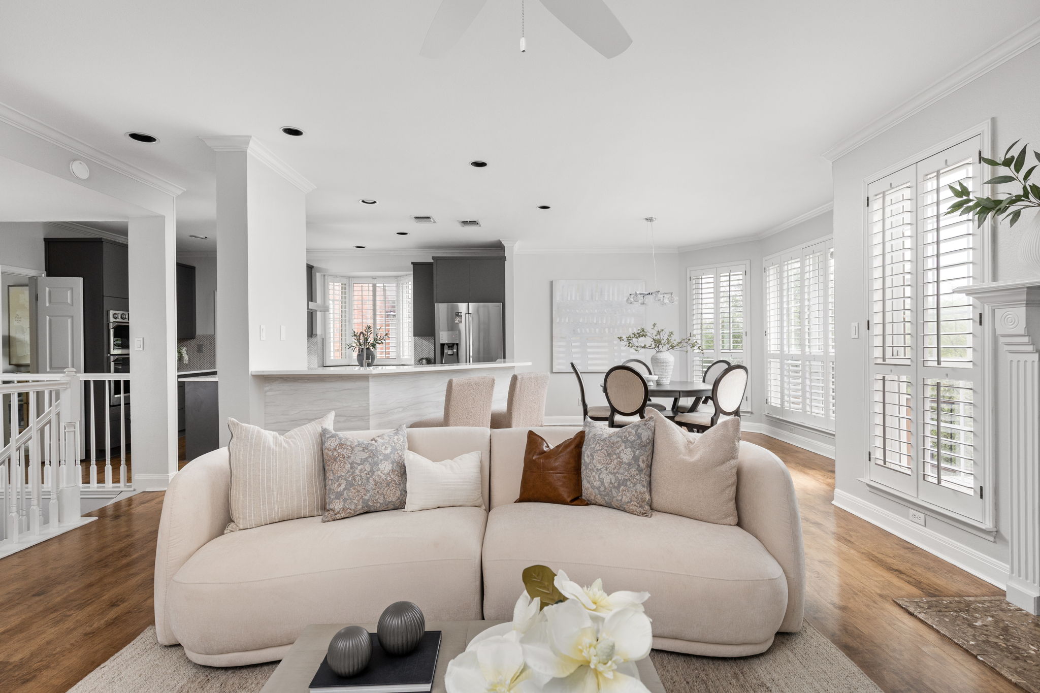 2807 Round Table Road Austin, TX 78746 - Photo 9 of 40 Open-concept living area with wood-finish flooring, recessed lighting, and white plantation shutters