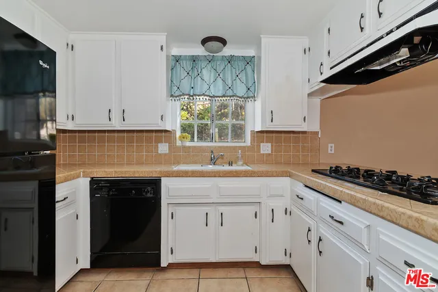 a kitchen with a refrigerator and a sink
