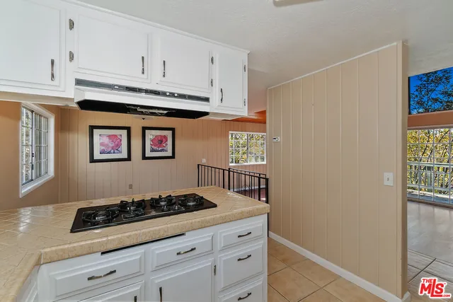 a kitchen with granite countertop cabinets a window and a sink