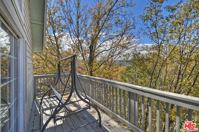 a view of a balcony with wooden floor