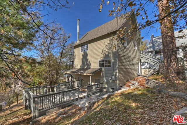 a view of a roof deck with wooden fence and floor