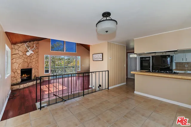 a kitchen with a refrigerator and window