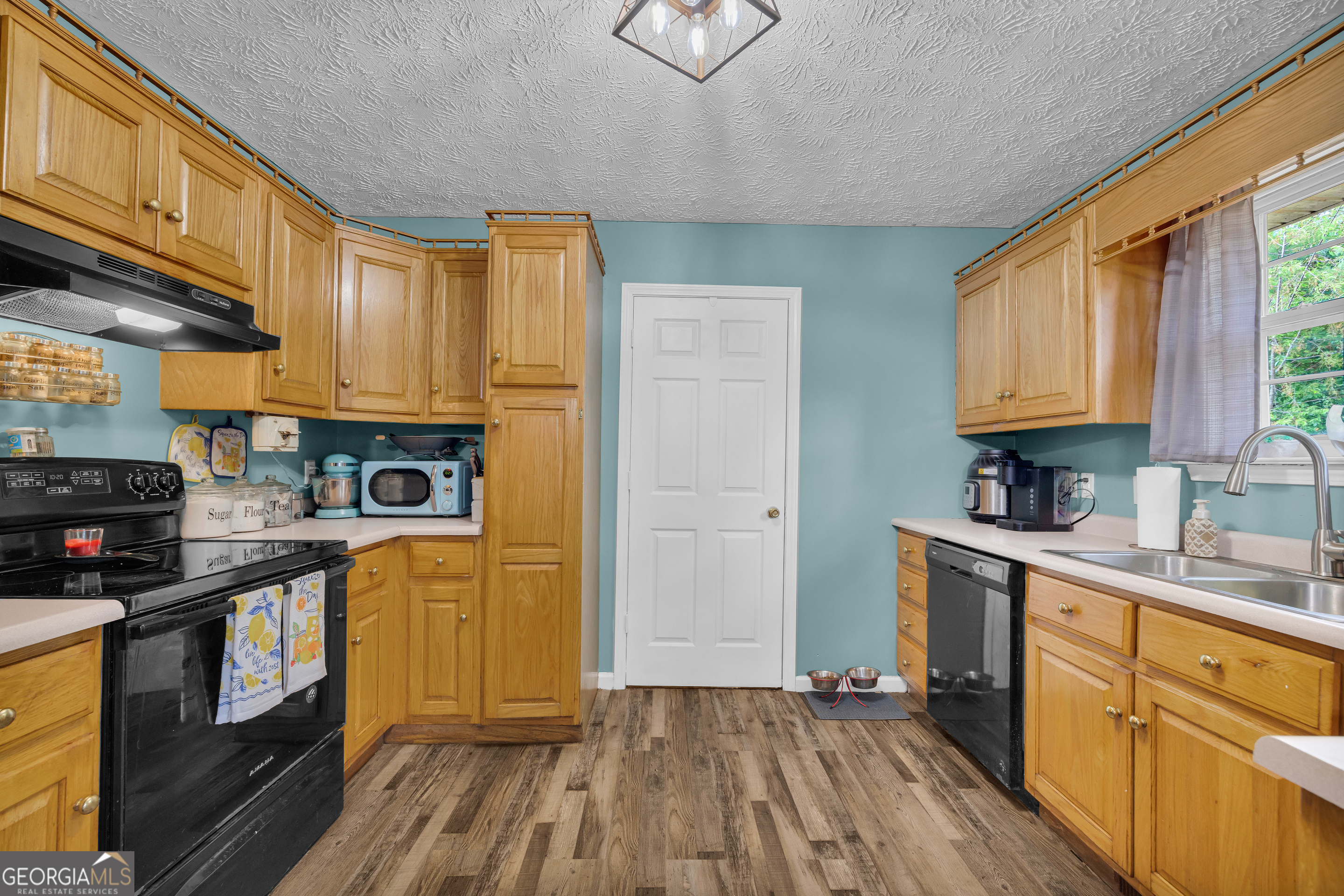 156 Shirley Road Royston, GA 30662 - Photo 8 of 29 a kitchen with stainless steel appliances granite countertop a stove a sink dishwasher and a refrigerator with wooden floor
