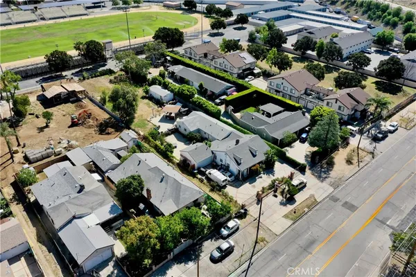 an aerial view of a house with a garden and lots of residential buildings