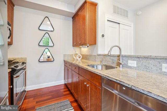 a kitchen with a sink cabinets and a window