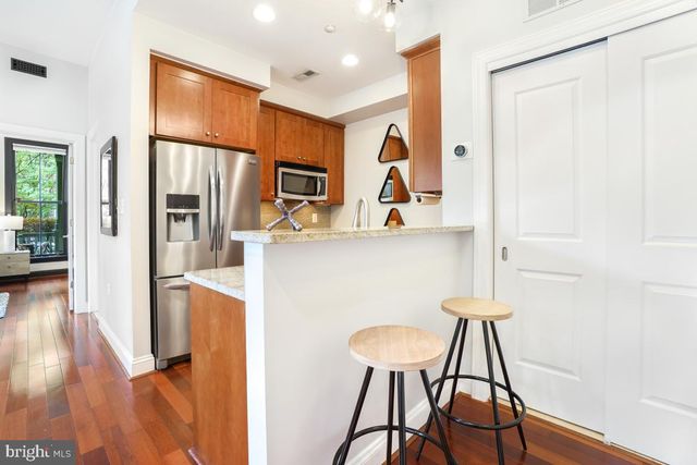 a kitchen with stainless steel appliances a refrigerator and a stove top oven