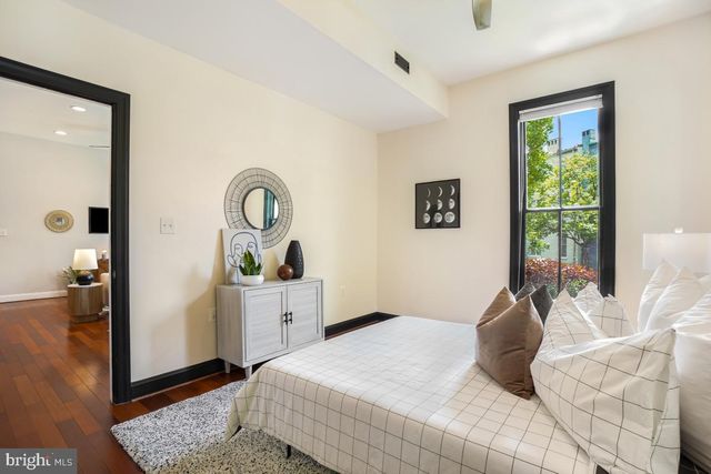 a bedroom with a bed and glass windows