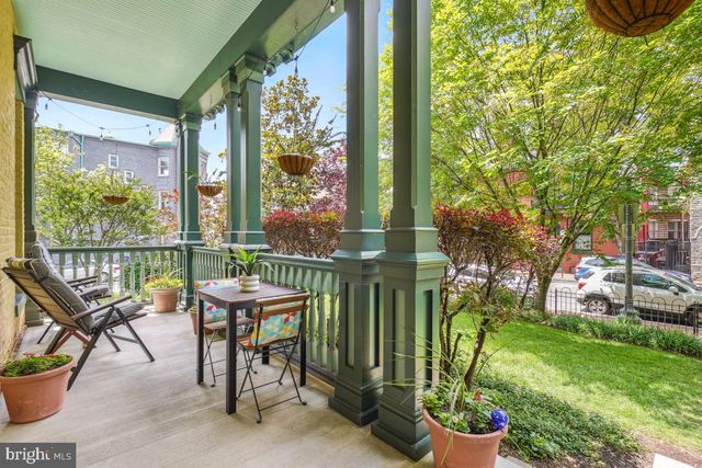 a view of a chairs and table in patio with a garden