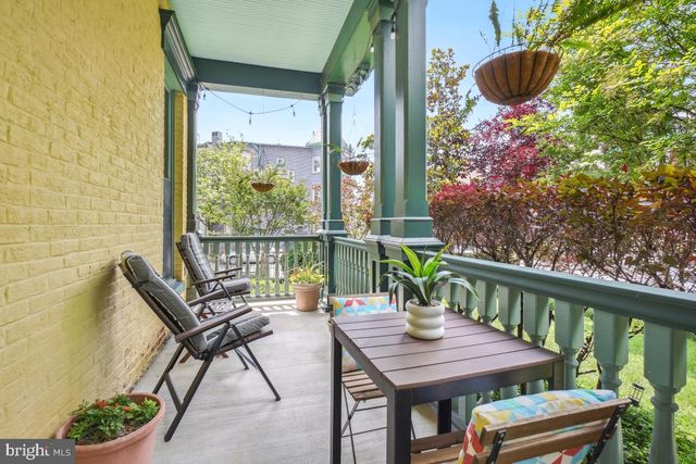 a view of a balcony with furniture and wooden floor