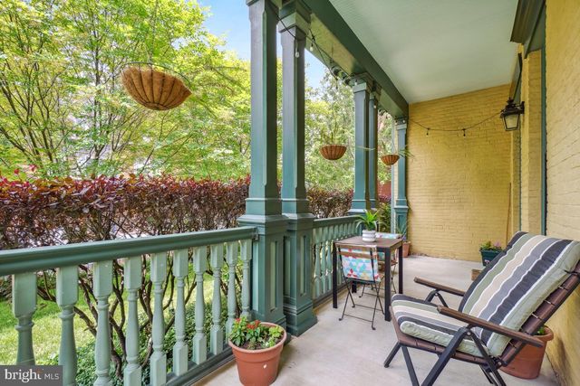 a view of a chairs and table in the balcony