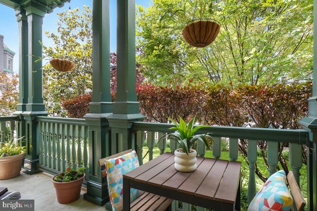a view of a balcony with chair and potted plants