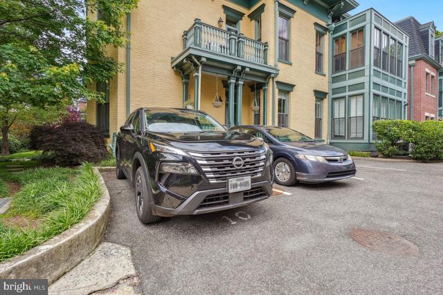 a car parked in front of a brick house