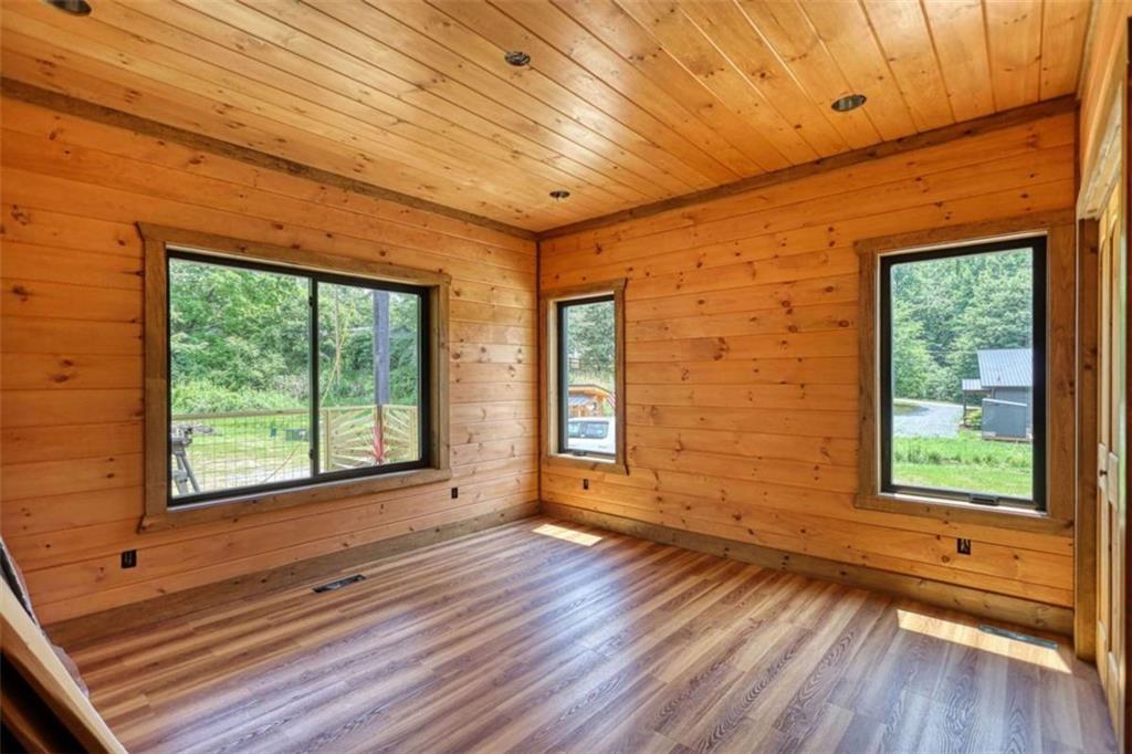 485 Church Street Blue Ridge, GA 30513 - Photo 21 of 85 a view of an empty room with a window and wooden floor