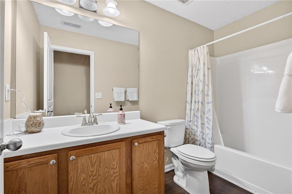 9 Darbys Run Way Hiram, GA 30141 - Photo 26 of 33 a bathroom with a sink a toilet a mirror a vanity and shower