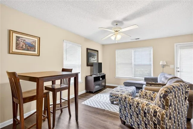 a living room with furniture and a wooden floor