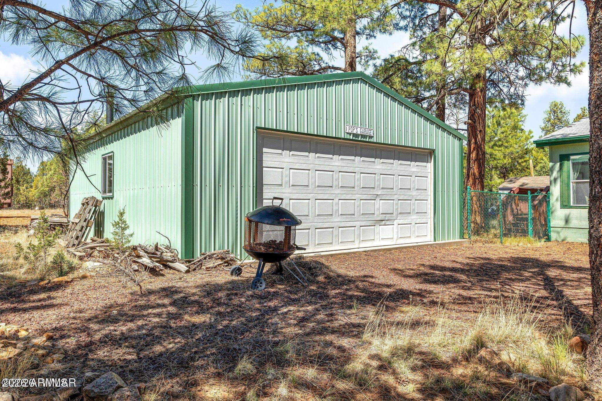 2908 Pine Rim Road, Unit LOT 7 Overgaard, AZ 85933 - Photo 17 of 24 a front view of a house with garden